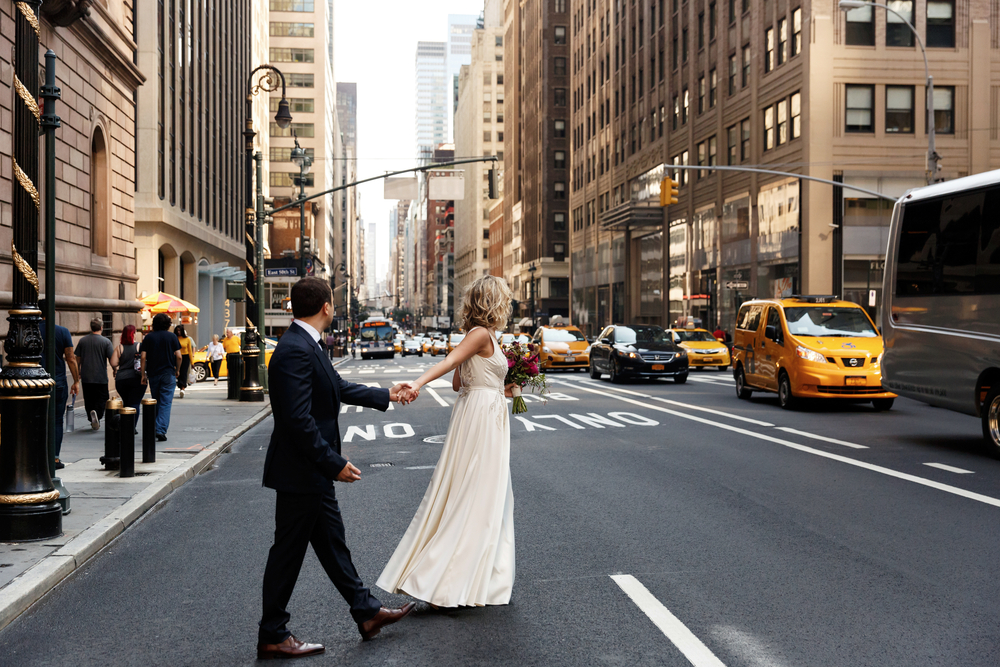 Bride,Holds,Groom's,Hand,Walking,Across,The,Street,In,New